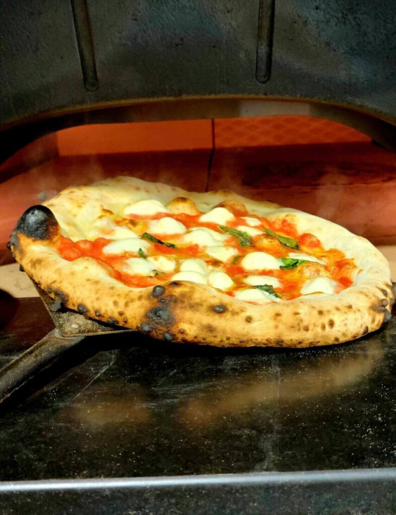 Guests making pizza together at the North American Pizza & Culinary Academy